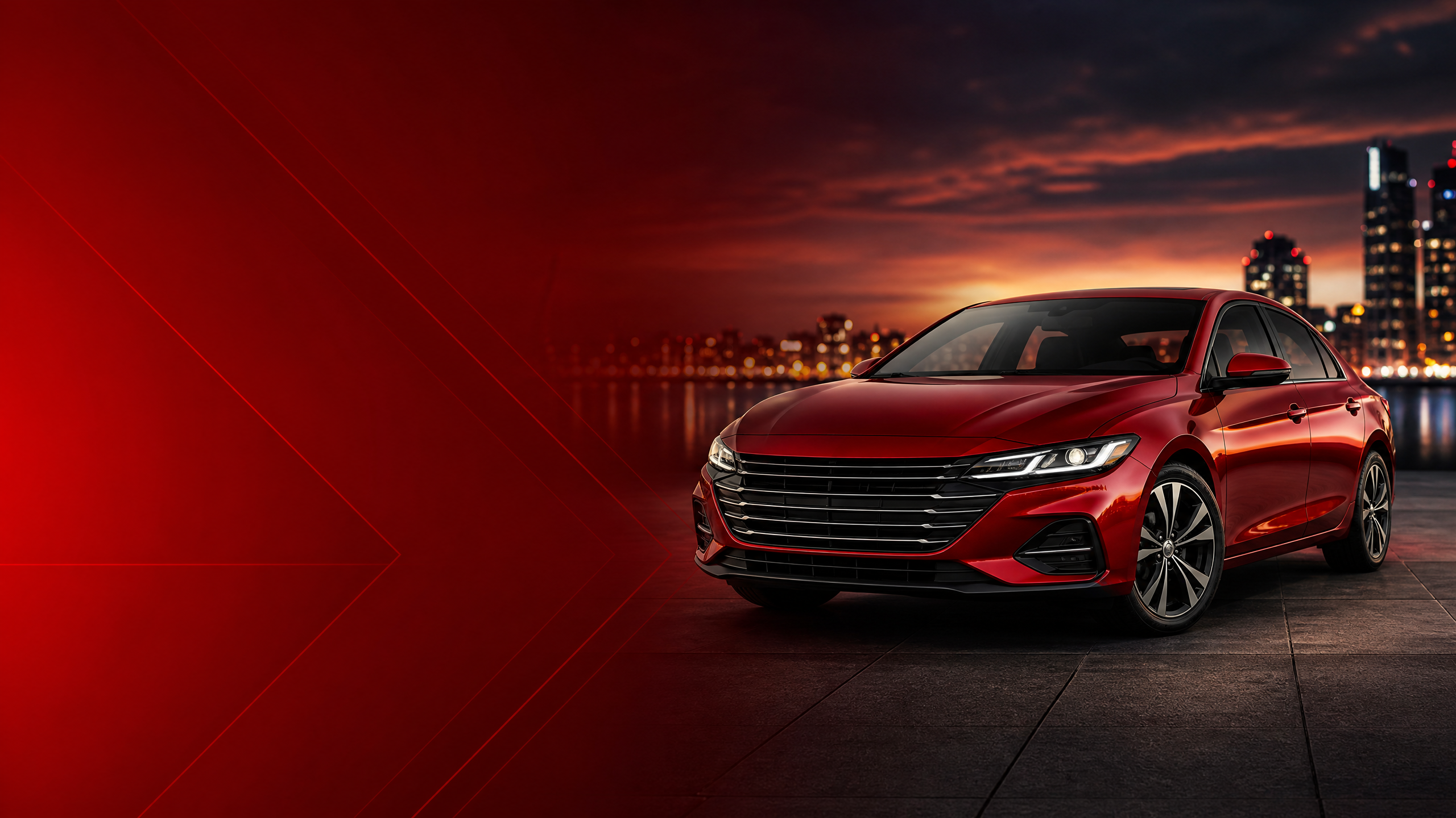 Carro vermelho iluminado com a cidade ao fundo